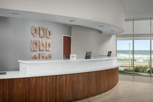 an office lobby with a reception desk with a view of the ocean at Courtyard Virginia Beach Oceanfront / North 37th Street in Virginia Beach