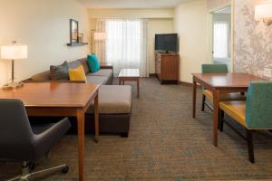 a living room with a couch and a table at Residence Inn by Marriott Portland North in Portland +13 photos