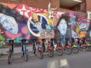 a group of bikes parked in front of a wall with graffiti at Auberge PVT Hostel in Montreal