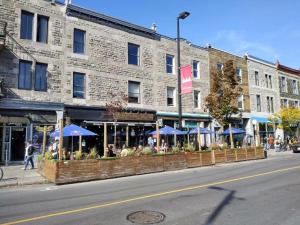 a building with blue umbrellas on the side of a street at Auberge PVT Hostel in Montreal