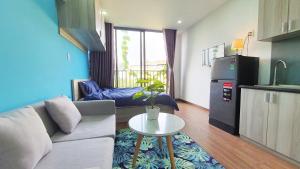 a living room with a couch and a table at The Art - Tina Hotel and Apartments in Ho Chi Minh City