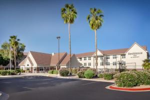 a hotel with palm trees in a parking lot at Residence Inn Phoenix Glendale/ Peoria in Peoria