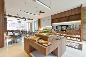 a large kitchen with a table with food on it at Grace Patong Hotel in Patong Beach