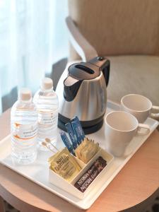 a tray with a tea kettle and cups on a table at Sama-Sama Express KLIA Terminal 2 - Airside Transit Hotel in Sepang