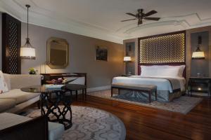 a bedroom with a bed and a living room at InterContinental Bali Resort by IHG in Jimbaran