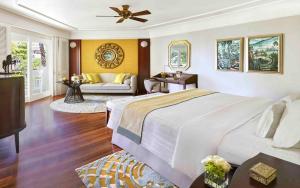 a bedroom with a large bed and a couch at InterContinental Bali Resort, an IHG Hotel in Jimbaran