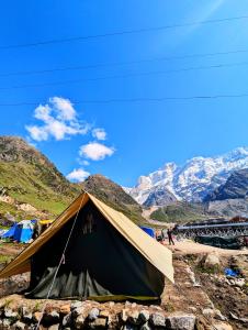 a tent on a mountain with mountains in the background at Kedar Tent House in Kedārnāth