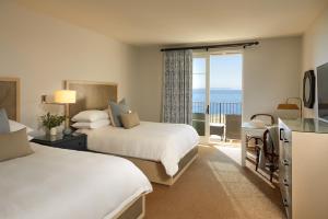 a hotel room with two beds and a view of the ocean at Terranea Resort in Rancho Palos Verdes