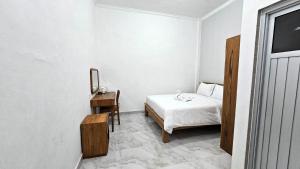 Ένα ή περισσότερα κρεβάτια σε δωμάτιο στο Umah Cenik