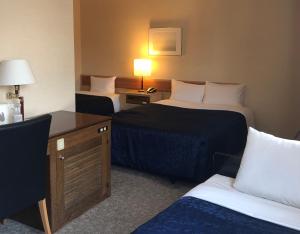 Postel nebo postele na pokoji v ubytování Asakusa Central Hotel