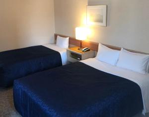 Postel nebo postele na pokoji v ubytování Asakusa Central Hotel