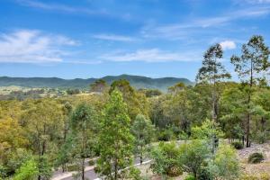 an aerial view of a forest with mountains in the background at Villa 3br Zinfandel Villa Resort Condo located within Cypress Lakes Resort nothing is more central in Pokolbin