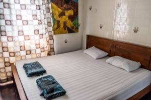 Postel nebo postele na pokoji v ubytování Discovery Youth Hostel Malacca