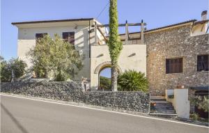a building with a stone wall next to a street at 2 Bedroom Awesome Home In Vado Ligure in Vado Ligure
