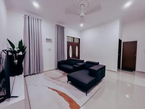 a living room with a couch and a chair at Ar-Rayyan 1 Homestay Kota Bharu in Kota Bharu