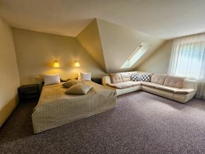 a large room with a bed and a couch at Irbēni in Brivkalni