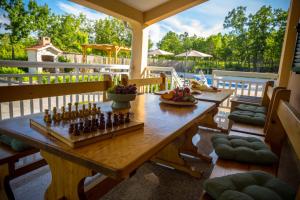 a wooden table with a chessboard on a deck at Holiday home 'Old oak' - with pool, garden with fresh vegetables and private forrest! in Imotski