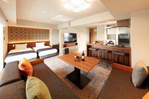 a hotel room with a bed and a living room at MONday Apart Premium Asakusa in Tokyo