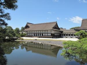 a large building with a pond in front of it at Marutamachi Crystal Hotel in Kyoto