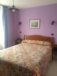 a bedroom with a bed with a colorful bedspread at Hotel Cluny Sorbonne in Paris