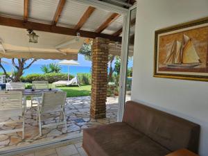 salon z kanapą i patio ze stołem w obiekcie Beachfront House 13 ,Glyfada w mieście Glifada