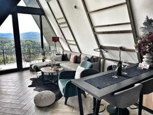 a living room with a couch and a table at Sarajevo Luxury Chalets in Sarajevo