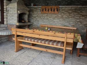 a wooden bench in front of a brick oven at Villa Puma in Balchik