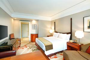 a hotel room with a bed and a couch at Jin Jiang Hotel in Shanghai