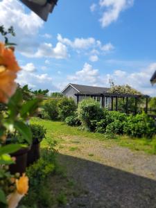 a garden with a building in the background at Helgas stuga i Jonstorp in Jonstorp