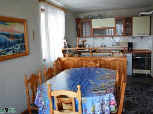 a kitchen with a table and a table and a kitchen with a table at Villa Puma in Balchik