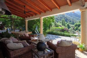 a patio with couches and a table with a view at Finca la Noguera-Sierra Cazorla in Quesada