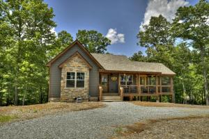 a home in the woods with a driveway at French Kisses in Ellijay