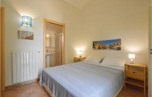 a bedroom with a white bed and two night stands at Villa Gina in Menfi