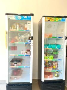 a refrigerator with its door open with food inside at Pererenan nengah guest house in Canggu