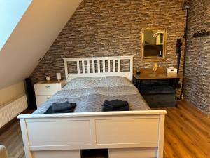 sypialnia z łóżkiem i ceglaną ścianą w obiekcie Nieman‘s Loft w mieście Emden