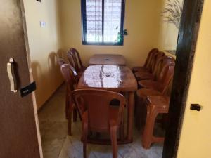 a dining room with a wooden table and chairs at Fulora Guest House only Family Welcomed in Kolthare