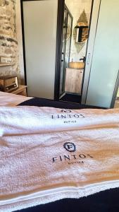 a towel on a bed in front of a mirror at Fintoz Butika in Karaburun