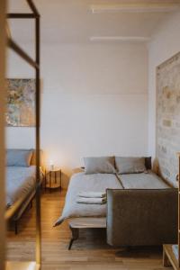 a bedroom with a bed and a couch at Garden House Apartments in Cēsis
