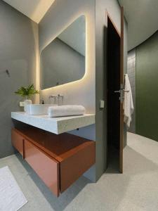 a bathroom with a sink and a mirror at Lighthouse Bingin - 360 view in Uluwatu