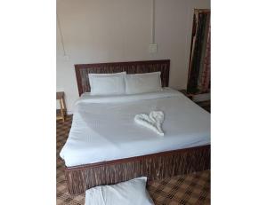 a bed with a heart shaped pillow on it at Hotel Royal sultan Resort, Pahalgam in Pahalgām