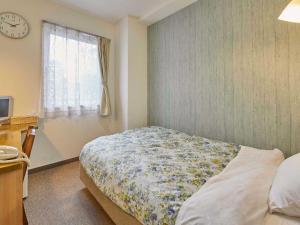 Postel nebo postele na pokoji v ubytování Kumagaya Royal Hotel Suzuki