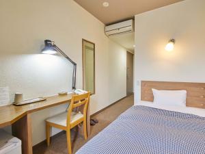 Postel nebo postele na pokoji v ubytování Kumagaya Royal Hotel Suzuki