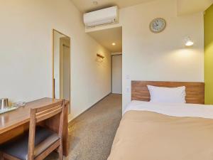 Postel nebo postele na pokoji v ubytování Kumagaya Royal Hotel Suzuki