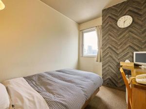 Postel nebo postele na pokoji v ubytování Kumagaya Royal Hotel Suzuki
