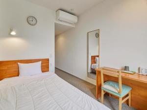 Postel nebo postele na pokoji v ubytování Kumagaya Royal Hotel Suzuki