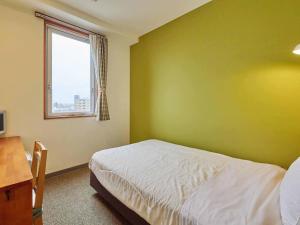 Postel nebo postele na pokoji v ubytování Kumagaya Royal Hotel Suzuki
