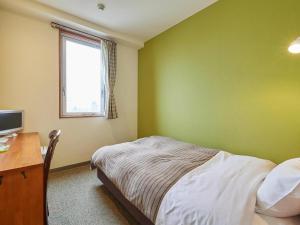 Postel nebo postele na pokoji v ubytování Kumagaya Royal Hotel Suzuki
