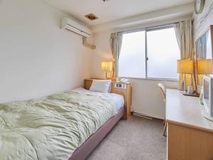 Postel nebo postele na pokoji v ubytování Kumagaya Royal Hotel Suzuki