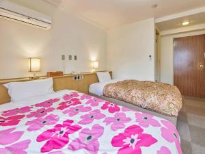 Postel nebo postele na pokoji v ubytování Kumagaya Royal Hotel Suzuki