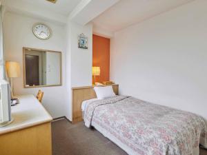 Postel nebo postele na pokoji v ubytování Kumagaya Royal Hotel Suzuki